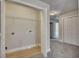 Functional closet space with shelving and hardwood flooring, connecting to the hallway at 506 Tallapoosa Trl, Woodstock, GA 30188