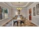 Elegant dining room with coffered ceiling, chandelier, and a view into the kitchen at 506 Tallapoosa Trl, Woodstock, GA 30188