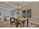 Inviting dining room with a modern chandelier, views of the living room and backyard at 506 Tallapoosa Trl, Woodstock, GA 30188