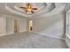 Spacious main bedroom with carpet floors, decorative tray ceilings and multiple entry points at 506 Tallapoosa Trl, Woodstock, GA 30188