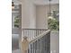 Bright staircase with iron railing, light gray walls, and a modern light fixture near the window at 506 Tallapoosa Trl, Woodstock, GA 30188