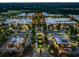 Aerial view of commercial district at twilight with roads, parking lots, storefronts and many trees at 6375 Haystack Ct, Cumming, GA 30040