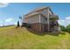 Spacious backyard featuring a lush lawn, basketball hoop, and a charming deck, ideal for outdoor activities at 6375 Haystack Ct, Cumming, GA 30040