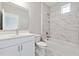 Modern bathroom featuring white vanity with brushed nickel hardware and a marble tile shower at 6375 Haystack Ct, Cumming, GA 30040