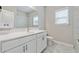 Modern bathroom featuring white vanity with brushed nickel hardware and a marble tile shower at 6375 Haystack Ct, Cumming, GA 30040