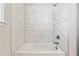 Modern bathroom featuring a white marble tile tub/shower combination with brushed nickel hardware at 6375 Haystack Ct, Cumming, GA 30040
