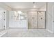 Spacious bathroom featuring a glass shower, double sink, and tiled floors at 6375 Haystack Ct, Cumming, GA 30040