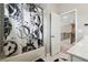 Bright bathroom featuring a tiled shower with a unique sports-themed shower curtain and white marble floors at 6375 Haystack Ct, Cumming, GA 30040