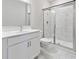 Modern bathroom featuring white vanity, marble floors, and a glass enclosed shower at 6375 Haystack Ct, Cumming, GA 30040