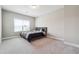 Bedroom featuring neutral carpet, light walls, and a large window that offers plenty of natural light at 6375 Haystack Ct, Cumming, GA 30040
