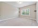 This bedroom features neutral walls, carpet and a large window with blinds at 6375 Haystack Ct, Cumming, GA 30040