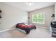 Neutral bedroom featuring a bed with a colorful comforter and a window that offers great natural light at 6375 Haystack Ct, Cumming, GA 30040