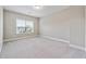 This bedroom features neutral walls, carpet and a large window with blinds at 6375 Haystack Ct, Cumming, GA 30040
