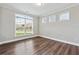 Bedroom featuring hardwood floors, multiple windows for natural light, and neutral paint at 6375 Haystack Ct, Cumming, GA 30040