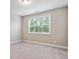 This bedroom features neutral walls, carpet and a large window with blinds at 6375 Haystack Ct, Cumming, GA 30040