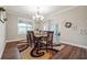 Dining room features wood-look floors, natural light, and an elegant chandelier at 6375 Haystack Ct, Cumming, GA 30040