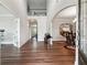 Open-concept entryway featuring wood-look flooring, arched doorways, and soaring ceilings at 6375 Haystack Ct, Cumming, GA 30040