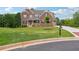 Charming brick home featuring manicured lawn, mature trees, and stately presence at 6375 Haystack Ct, Cumming, GA 30040