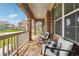 Inviting front porch with comfortable seating, stone floor, and brick archway offers a relaxing outdoor space at 6375 Haystack Ct, Cumming, GA 30040