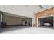 Spacious three-car garage with epoxy flooring and storage space offers ample room for vehicles and gear at 6375 Haystack Ct, Cumming, GA 30040