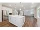 Spacious kitchen featuring a large island, stainless steel appliances, and open access to living spaces at 6375 Haystack Ct, Cumming, GA 30040