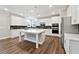 Bright kitchen boasts a center island, stainless steel appliances, and white cabinets at 6375 Haystack Ct, Cumming, GA 30040