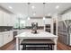 Bright kitchen features a large island, stainless steel appliances, and a modern backsplash at 6375 Haystack Ct, Cumming, GA 30040
