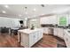 Well-lit kitchen with a central island, stainless steel appliances, and an adjacent dining area at 6375 Haystack Ct, Cumming, GA 30040