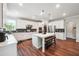 Modern kitchen boasting white cabinets, stainless steel appliances, and a large center island at 6375 Haystack Ct, Cumming, GA 30040