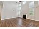 Open living room with high ceilings, hardwood floors, a fireplace, and a decorative wall clock at 6375 Haystack Ct, Cumming, GA 30040