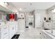 Spacious bathroom featuring double sinks, a soaking tub and a separate shower with light gray walls and floors at 6375 Haystack Ct, Cumming, GA 30040