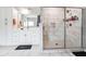 Sleek primary bathroom boasting a walk-in shower with floor to ceiling tile and double vanity at 6375 Haystack Ct, Cumming, GA 30040