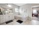 Luxurious primary bathroom with a soaking tub, double vanity, and elegant tile work at 6375 Haystack Ct, Cumming, GA 30040