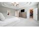 Relaxing primary bedroom featuring a tray ceiling, neutral palette, and ample closet space at 6375 Haystack Ct, Cumming, GA 30040