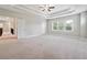 Bright main bedroom with tray ceilings, neutral paint, and large windows at 6375 Haystack Ct, Cumming, GA 30040