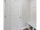 Mudroom featuring a white door, beadboard, bench, and hooks with vinyl wood look floor at 6375 Haystack Ct, Cumming, GA 30040