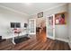 Bright home office with wood-look floors, modern desk setup, and double glass doors at 6375 Haystack Ct, Cumming, GA 30040
