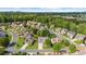 A high-angle shot showcases a residential neighborhood with lush landscaping and well-maintained homes under a clear sky at 100 Inspiration Ln, Dallas, GA 30157