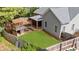 Backyard featuring a playhouse, screened in porch and well-maintained lawn at 100 Inspiration Ln, Dallas, GA 30157