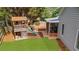 Landscaped backyard with a playset, screened in porch and lush green lawn at 100 Inspiration Ln, Dallas, GA 30157