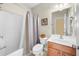 Well-lit bathroom featuring a vanity, mirror, and shower-tub combination at 100 Inspiration Ln, Dallas, GA 30157