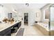 Bright bathroom features dual vanities, a soaking tub, and a walk-in closet at 100 Inspiration Ln, Dallas, GA 30157