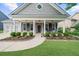 Inviting home exterior with a charming front porch, lush lawn, and two-car garage at 100 Inspiration Ln, Dallas, GA 30157