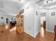 Bright hallway with hardwood floors, connecting the main living areas of the home at 100 Inspiration Ln, Dallas, GA 30157