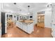 Open-concept kitchen island featuring granite countertops and stainless steel sink at 100 Inspiration Ln, Dallas, GA 30157