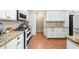 Modern kitchen with stainless steel appliances, granite countertops, and white cabinets at 100 Inspiration Ln, Dallas, GA 30157