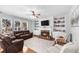 Inviting living room boasts a brick fireplace, built-in shelves, and large windows at 100 Inspiration Ln, Dallas, GA 30157