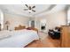 Relaxing main bedroom with tray ceiling, a ceiling fan, and neutral decor at 100 Inspiration Ln, Dallas, GA 30157