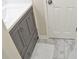 Modern bathroom vanity with gray cabinets and marble-style tile flooring at 1676 Northridge Dr, Morrow, GA 30260