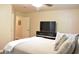 Well-lit bedroom with soft bedding, a TV, and hardwood floors at 1676 Northridge Dr, Morrow, GA 30260